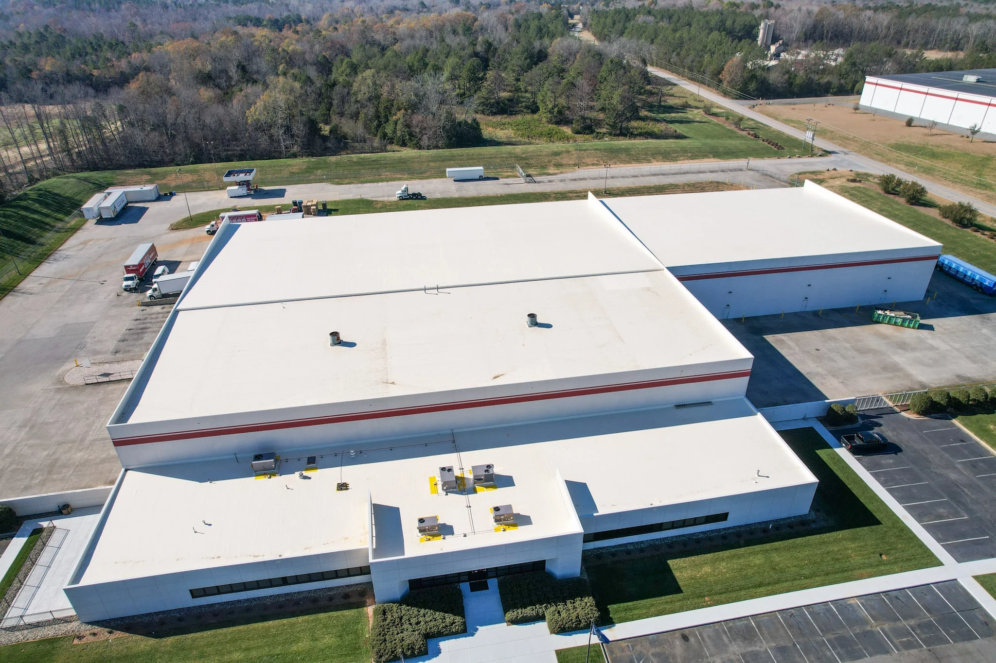 Large commercial flat roof inspected for repair or replacement